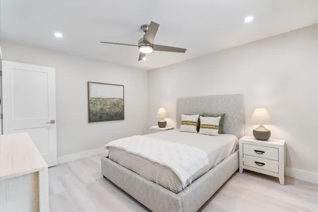 a bedroom with a bed and a night stand