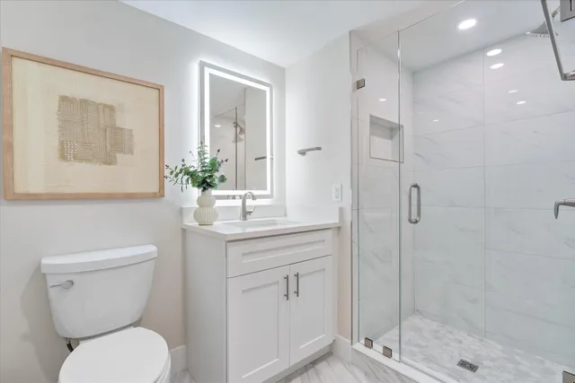 a bathroom with a toilet sink and shower