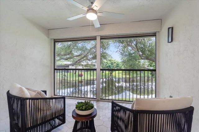 a room with furniture and large windows