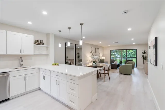 a large white kitchen with a large window