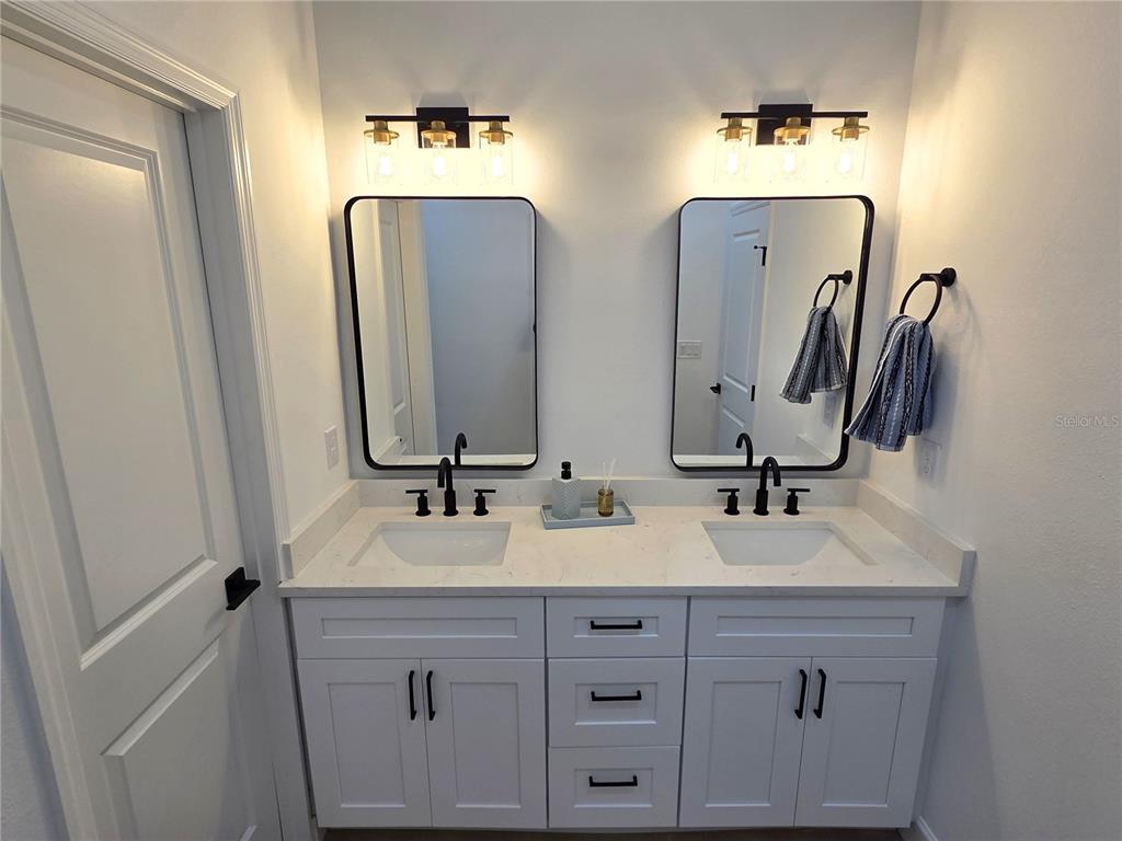 2967 Barry Road North Port, FL 34286 - Photo 12 of 19 a bathroom with double vanity sinks and a mirror