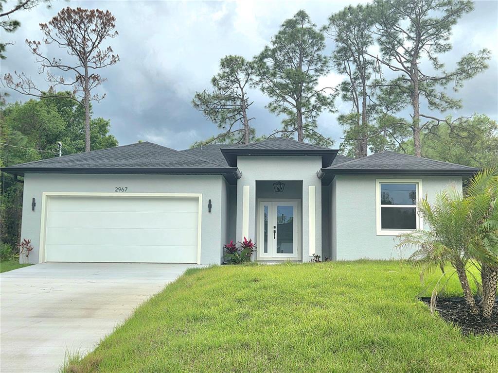 2967 Barry Road North Port, FL 34286 - Photo 19 of 19 a front view of a house with a yard and garage
