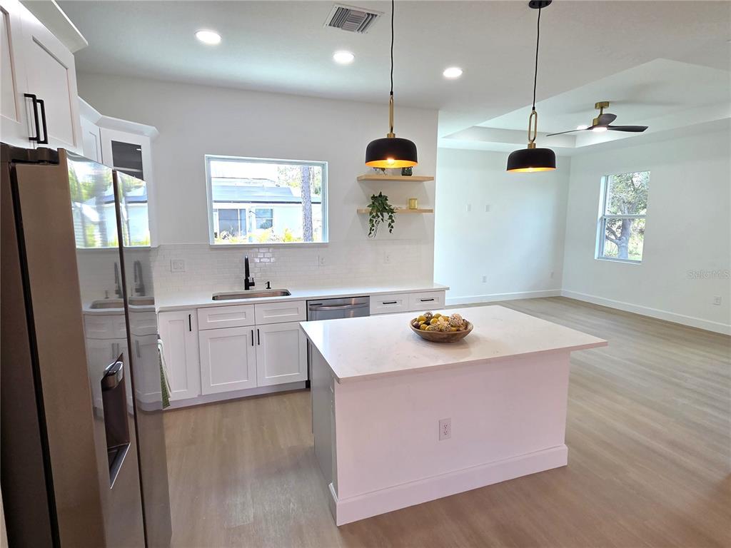 2967 Barry Road North Port, FL 34286 - Photo 7 of 19 a kitchen with stainless steel appliances granite countertop a sink a refrigerator and a stove