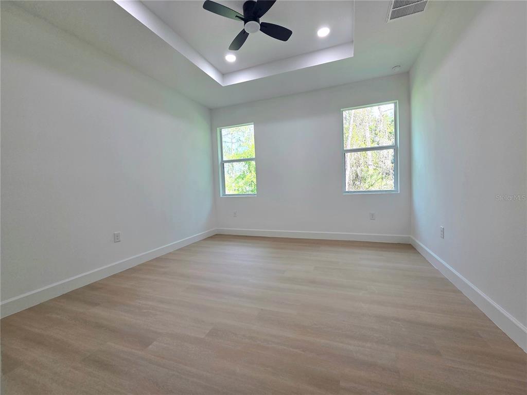 2967 Barry Road North Port, FL 34286 - Photo 10 of 19 an empty room with a window and a ceiling fan