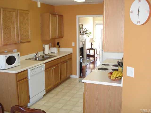 4105 Scofield Drive Raleigh, NC 27610 - Photo 4 of 7 a kitchen with a sink a stove and refrigerator