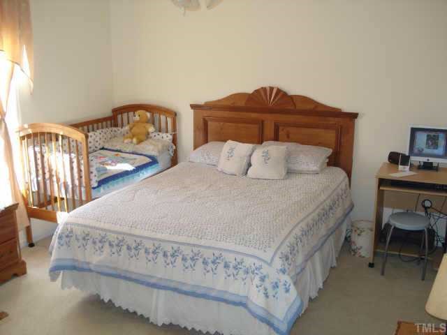 4105 Scofield Drive Raleigh, NC 27610 - Photo 5 of 7 a bedroom with bed and window