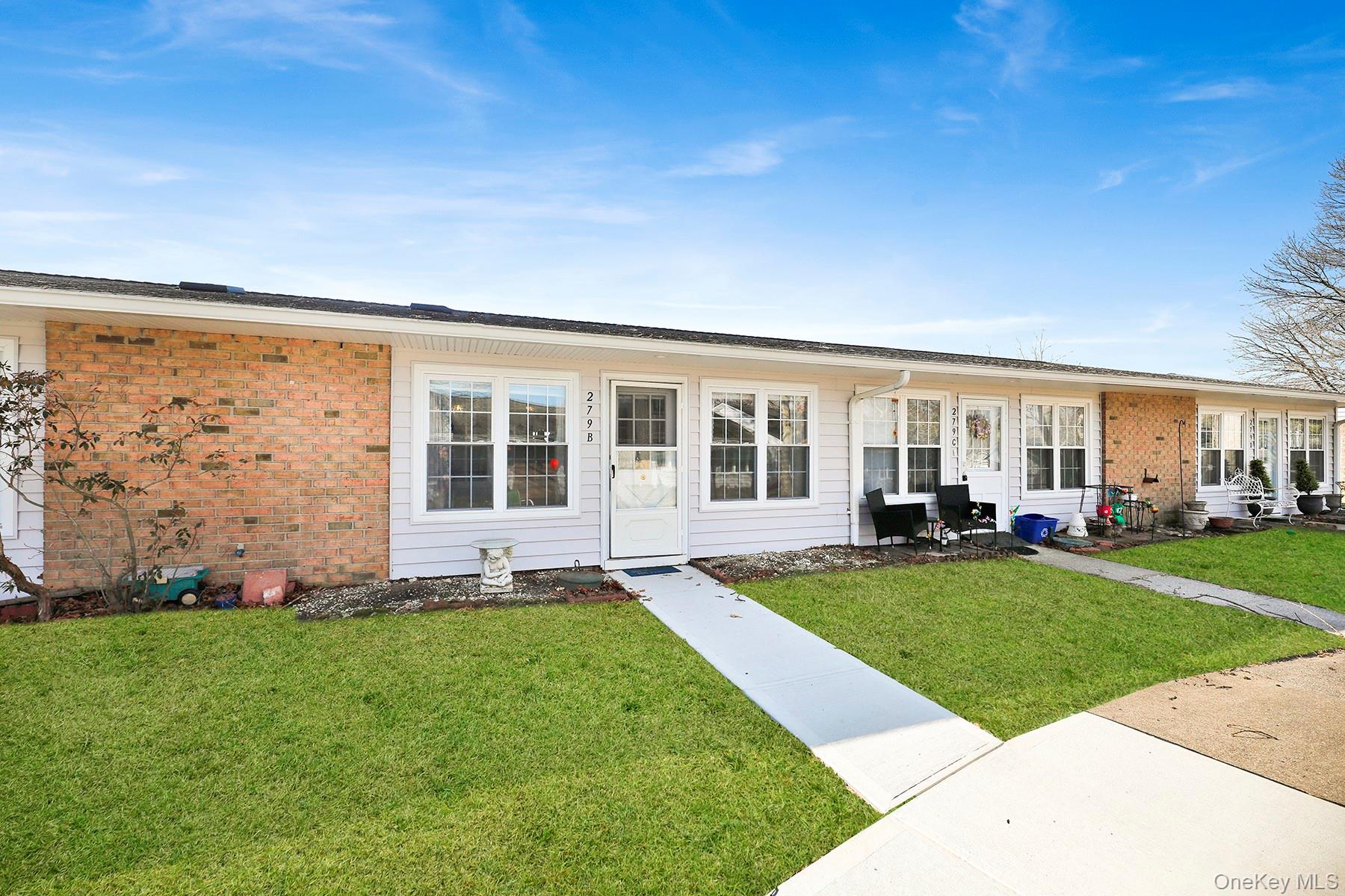 279 Berwick Court, Unit B Ridge, NY 11961 - Photo 12 of 13 a view of a house with backyard with sitting area