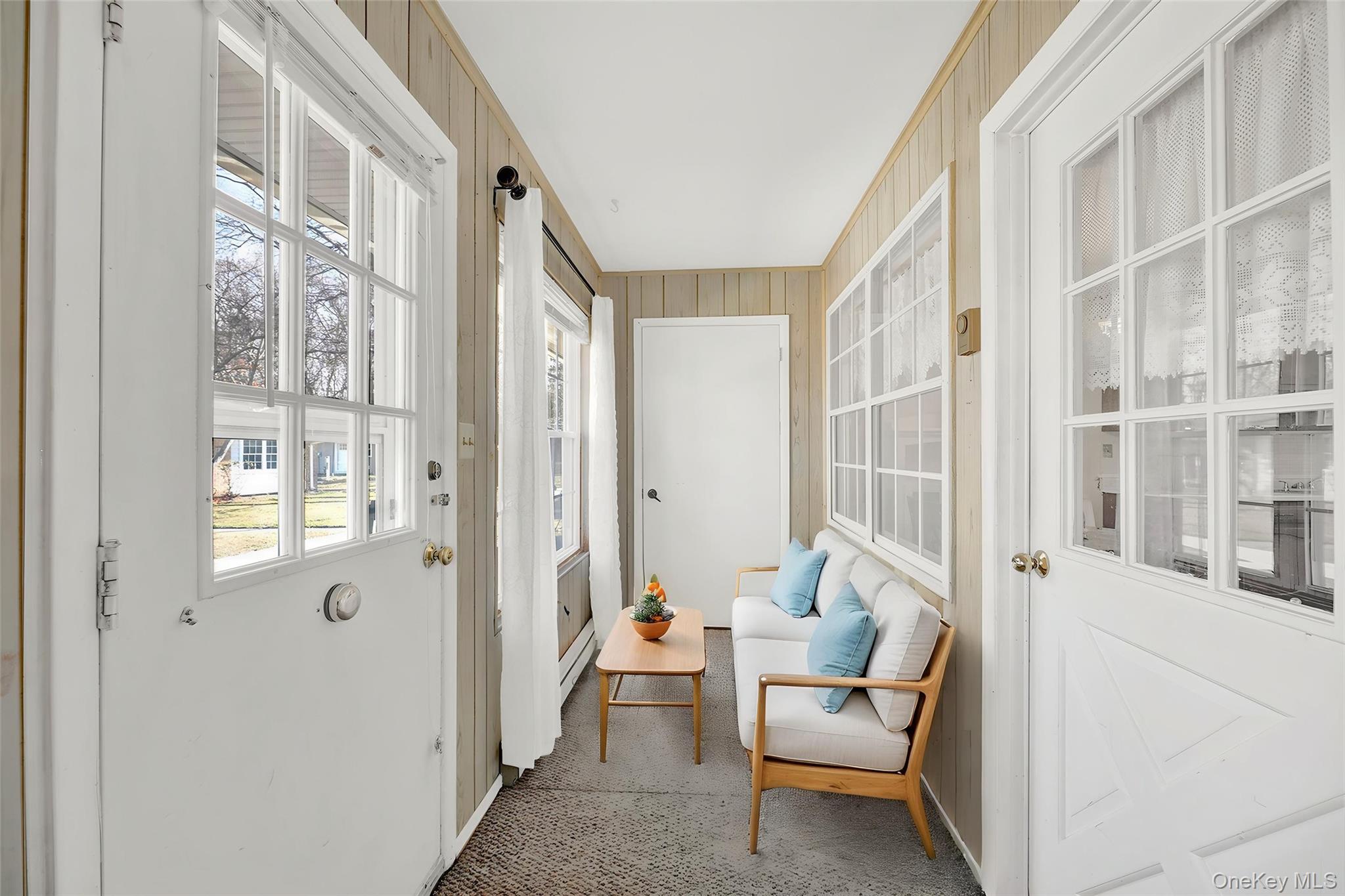 279 Berwick Court, Unit B Ridge, NY 11961 - Photo 2 of 13 a living room with furniture and a large window