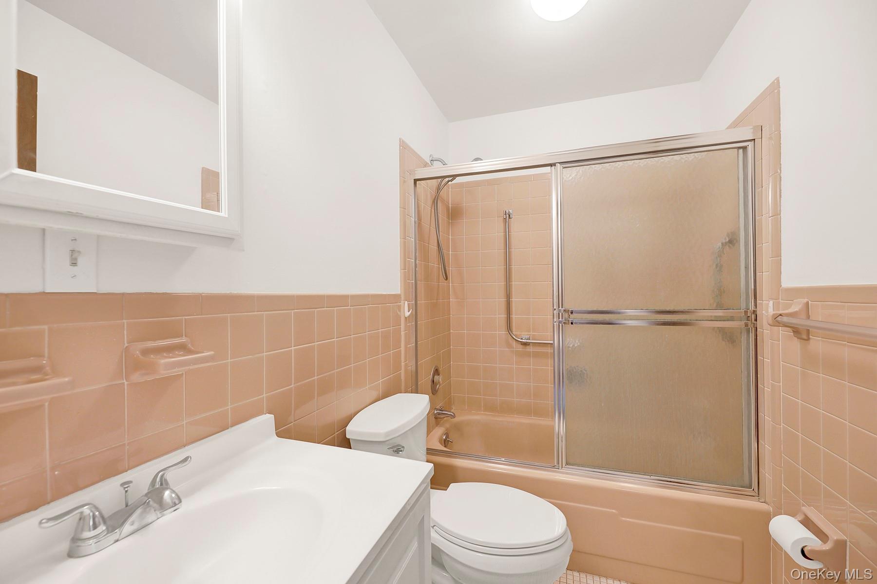 279 Berwick Court, Unit B Ridge, NY 11961 - Photo 10 of 13 a bathroom with a toilet sink and shower