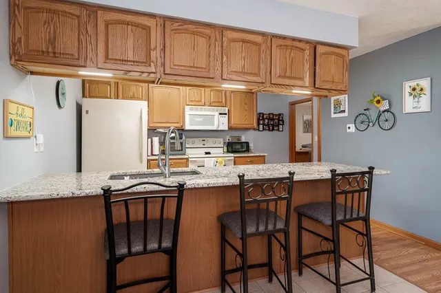 a kitchen with stainless steel appliances granite countertop a sink and cabinets