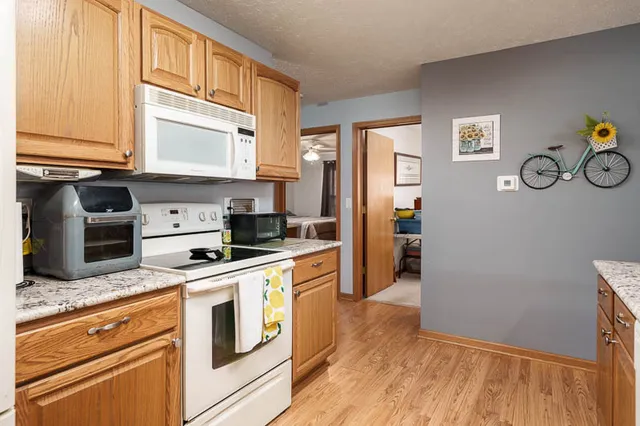 a kitchen with stainless steel appliances granite countertop a refrigerator and a stove top oven