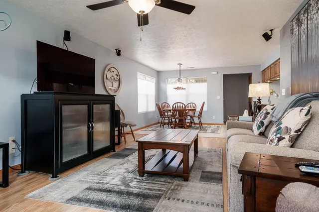 a living room with furniture a flat screen tv and a fireplace
