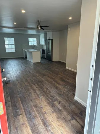 a view of a kitchen with a sink and a refrigerator