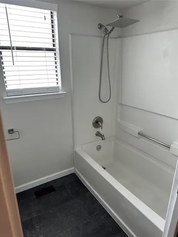 a bathroom with a bath tub and a shower