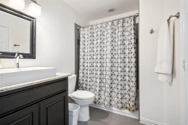 a bedroom with a bed a lamp and a window