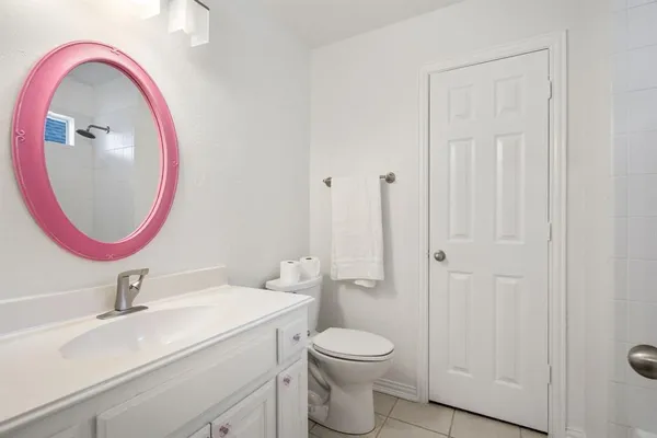 a bathroom with a toilet a sink and a mirror