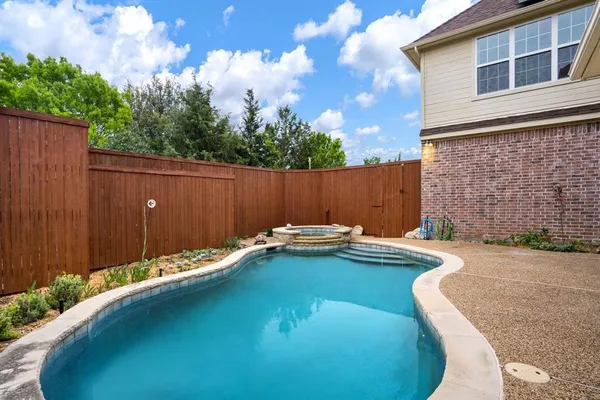 a view of house with swimming pool outdoor seating