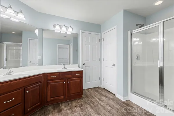 a spacious bathroom with a double vanity sink mirror and double