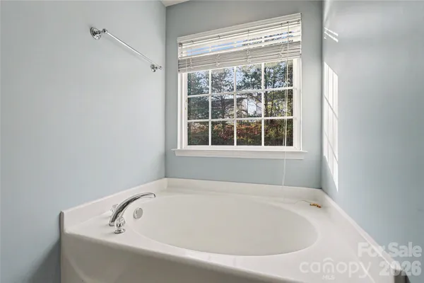a white bath tub sitting next to a window