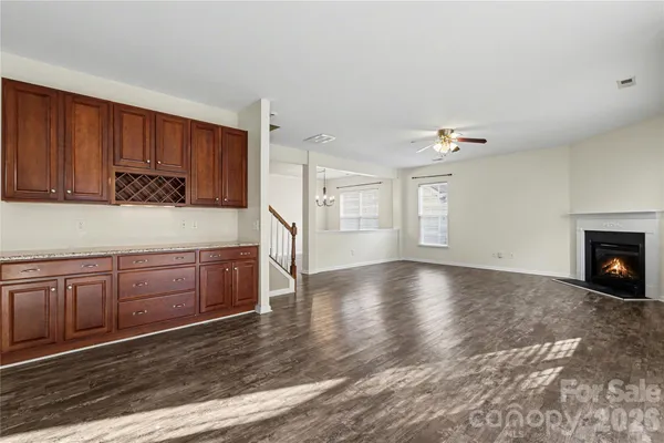 a kitchen with granite countertop a stove cabinets and wooden floor