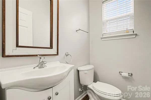 a bathroom with a sink a toilet and a mirror