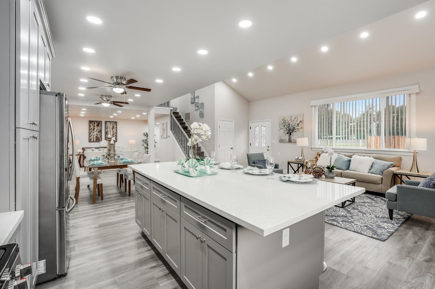 17675 Laurel Road Morgan Hill, CA 95037 - Photo 12 of 48 a large kitchen with kitchen island a sink a counter top space and living room view