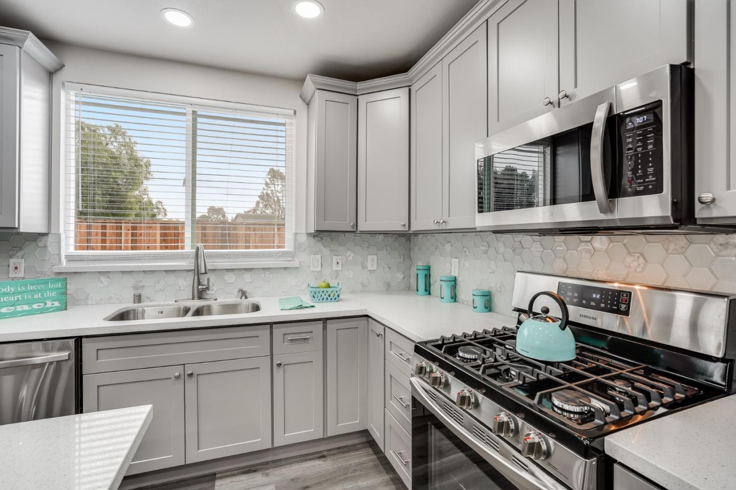 17675 Laurel Road Morgan Hill, CA 95037 - Photo 14 of 48 a kitchen with stainless steel appliances granite countertop a sink stove top oven and cabinets