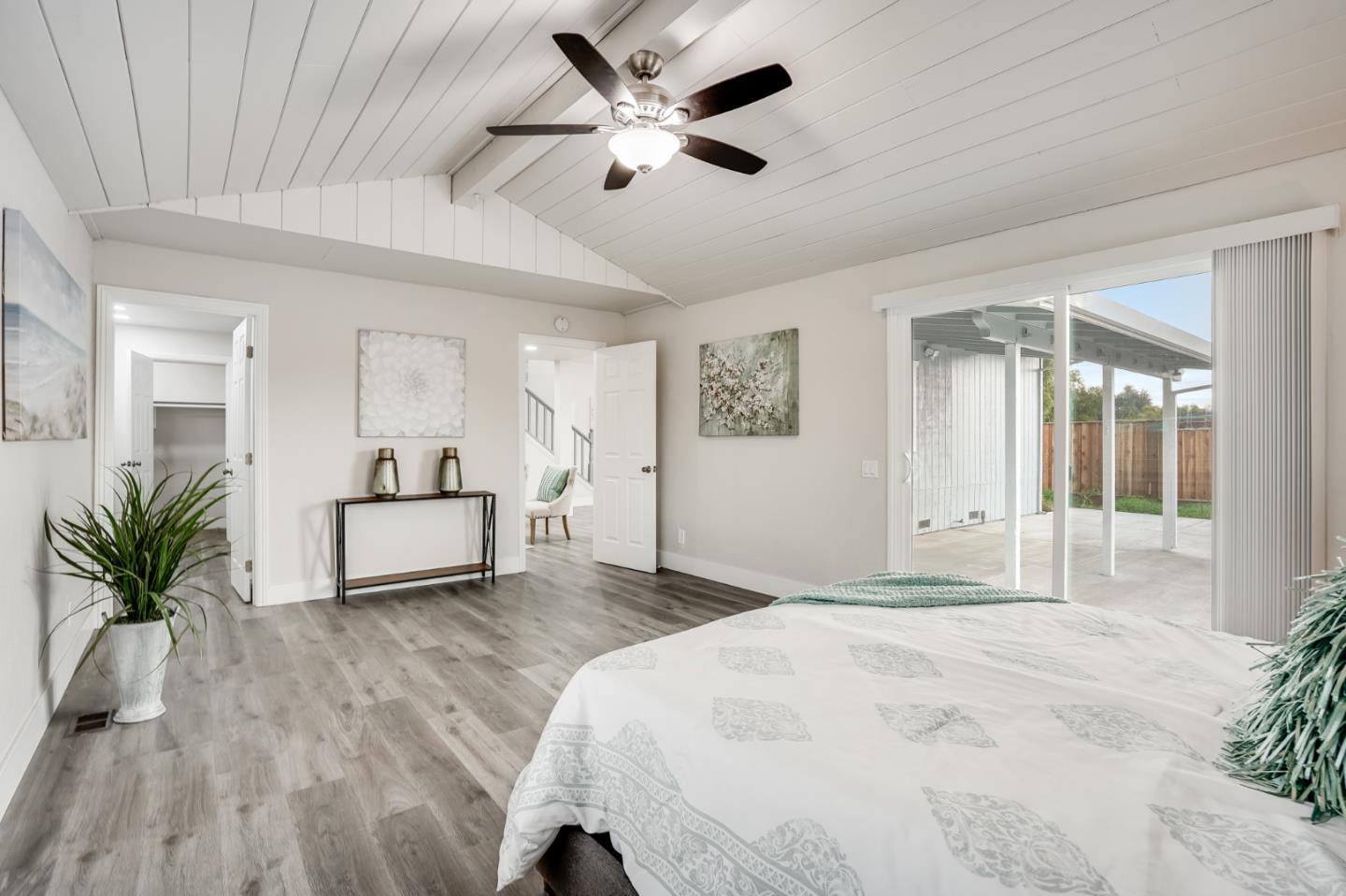 17675 Laurel Road Morgan Hill, CA 95037 - Photo 19 of 48 a white bed sitting in a spacious bedroom next to a window and a chandelier