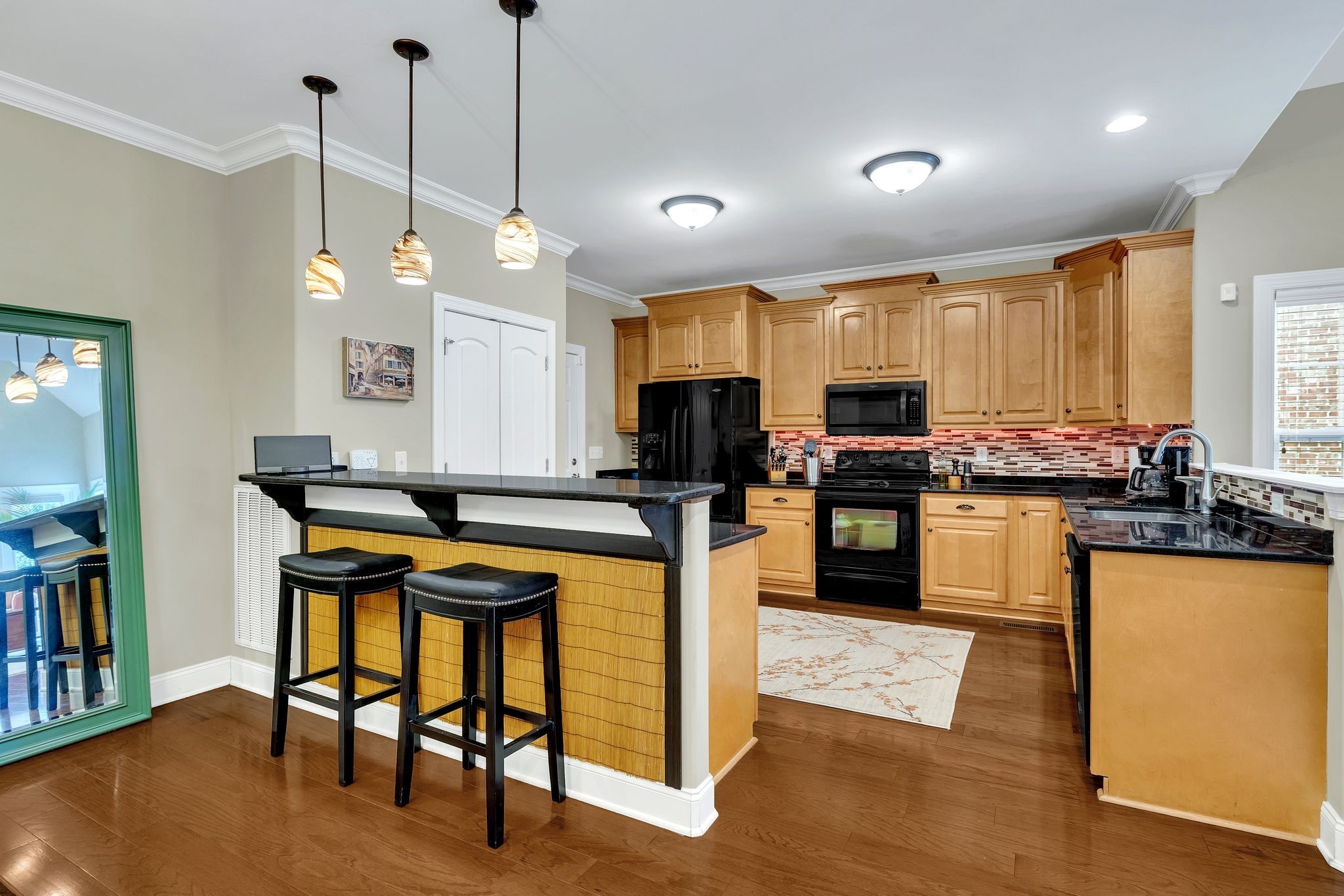 2009 Sunflower Drive Spring Hill, TN 37174 - Photo 19 of 34 a kitchen with stainless steel appliances kitchen island granite countertop a stove a sink and a refrigerator