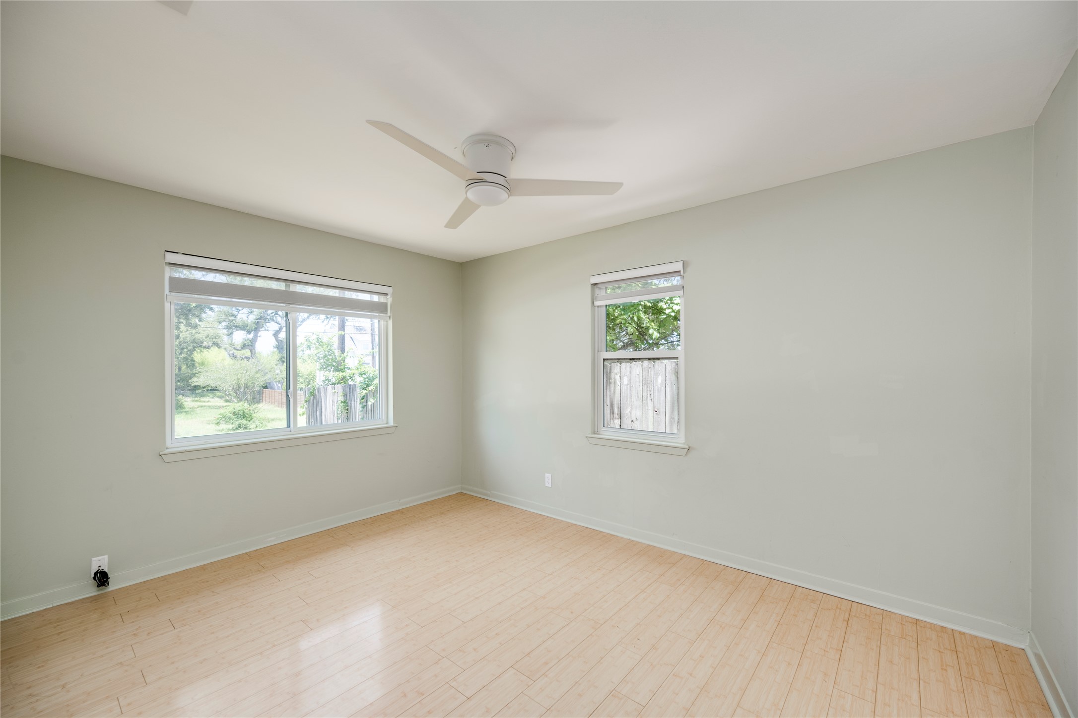 1707 Overhill Drive Austin, TX 78721 - Photo 15 of 36 A quiet bedroom offers serene outdoor views and easy-care flooring.