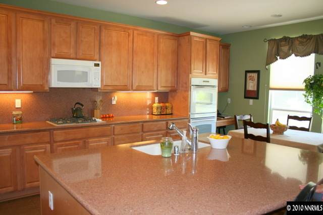 530 Secretariat Court Reno, NV 89521 - Photo 5 of 13 a kitchen with a sink a stove and cabinets