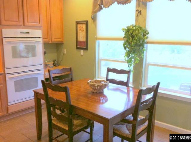 530 Secretariat Court Reno, NV 89521 - Photo 8 of 13 a dining room with furniture and a potted plant