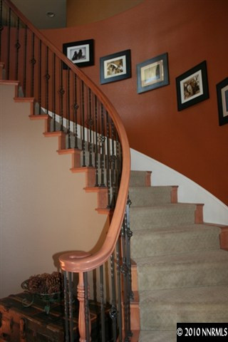 530 Secretariat Court Reno, NV 89521 - Photo 10 of 13 a view of staircase with lots of frames on wall and wooden floor