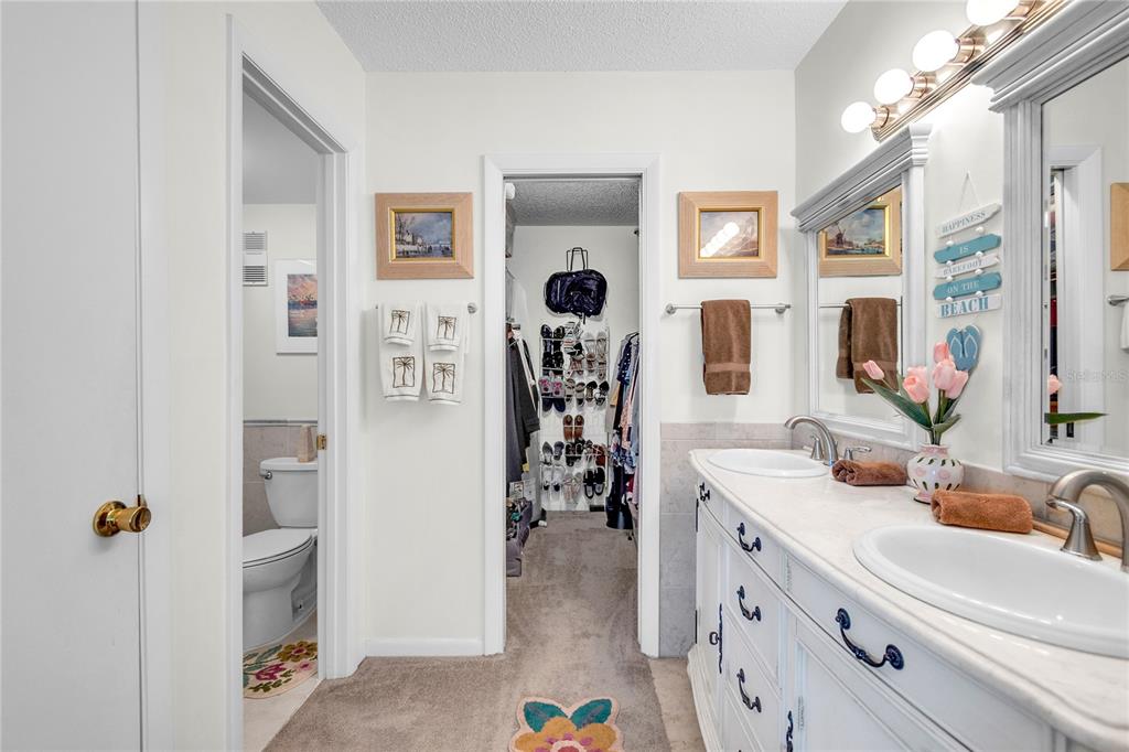 12200 Vonn Road, Unit 2206 Largo, FL 33774 - Photo 35 of 60 a bathroom with a sink a mirror and a shower