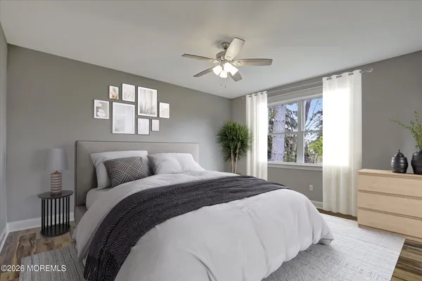 a bedroom with a large bed and a chandelier