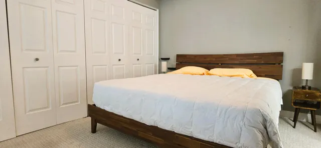 a bedroom with a bed and chair