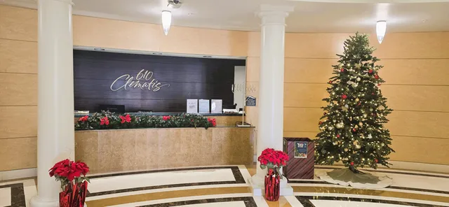 a vase of flowers sitting on a floor in front of a door