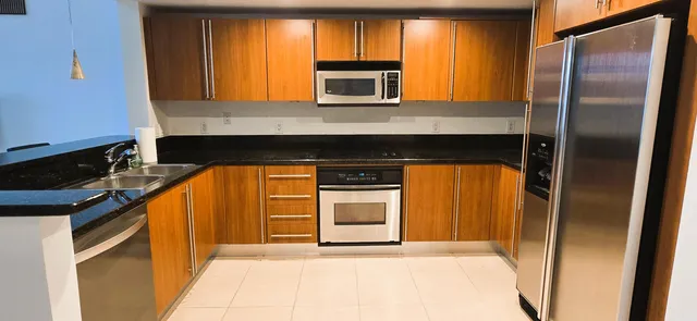 a kitchen with a refrigerator and a microwave