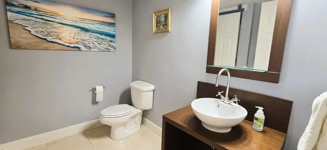 a bathroom with a toilet sink and mirror