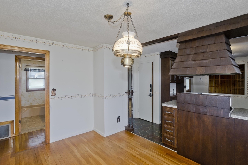 83 Mayflower Avenue Chicopee, MA 01013 - Photo 11 of 34 a room that has a bed and a chandelier