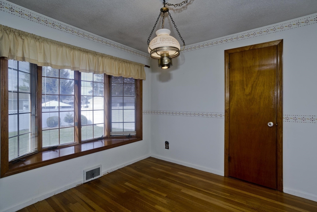 83 Mayflower Avenue Chicopee, MA 01013 - Photo 12 of 34 a view of empty room with wooden floor and fan
