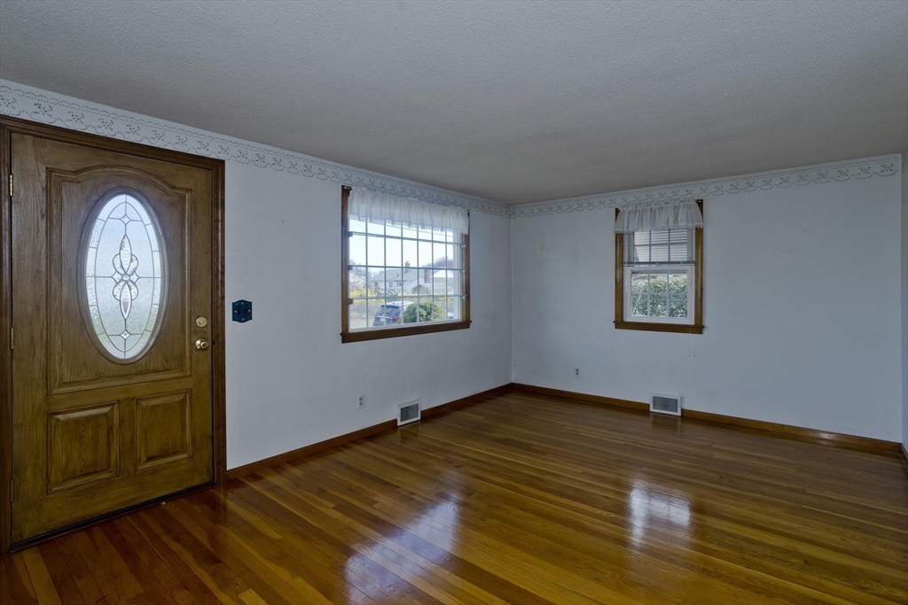 83 Mayflower Avenue Chicopee, MA 01013 - Photo 13 of 34 an empty room with wooden floor closet and windows