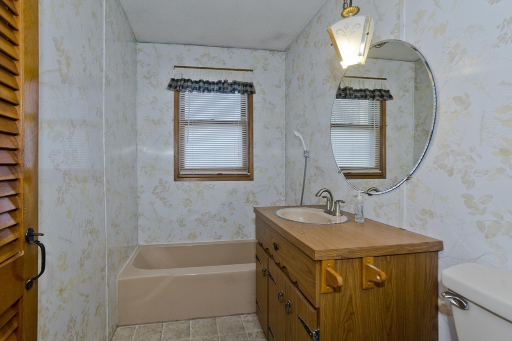 83 Mayflower Avenue Chicopee, MA 01013 - Photo 18 of 34 a bathroom with a tub sink and mirror