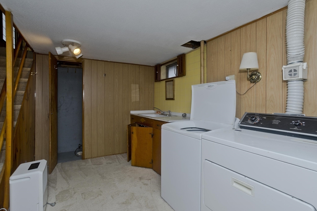 83 Mayflower Avenue Chicopee, MA 01013 - Photo 22 of 34 a view of a storage & utility room with two washing machine