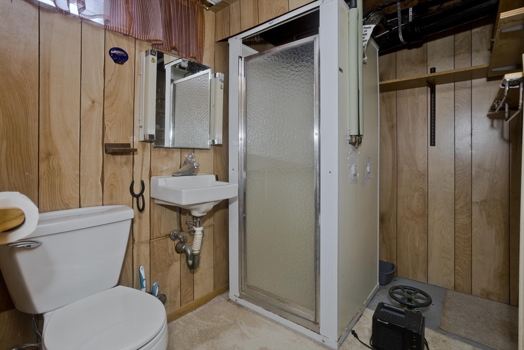 83 Mayflower Avenue Chicopee, MA 01013 - Photo 27 of 34 a bathroom with a granite countertop toilet sink and shower