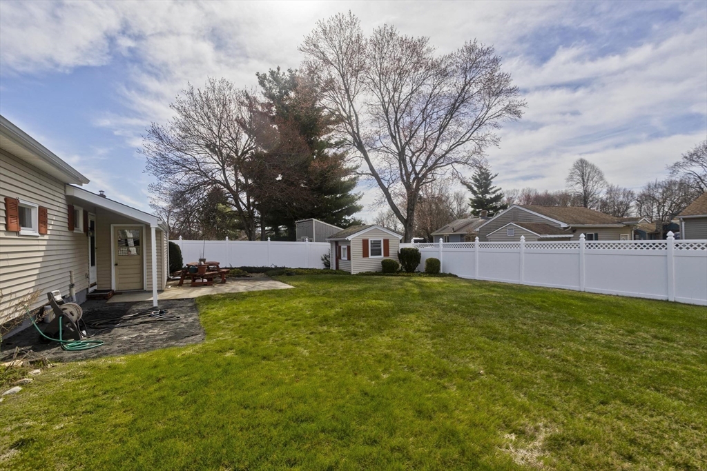 83 Mayflower Avenue Chicopee, MA 01013 - Photo 31 of 34 a view of a yard with a house in the background