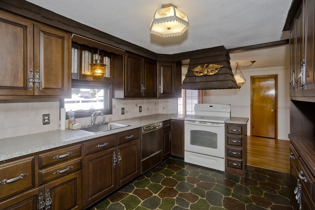 83 Mayflower Avenue Chicopee, MA 01013 - Photo 8 of 34 a kitchen with a sink window and cabinets