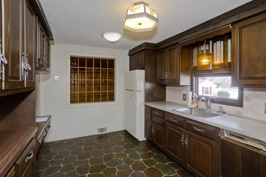 83 Mayflower Avenue Chicopee, MA 01013 - Photo 9 of 34 a kitchen with stainless steel appliances granite countertop a sink stove and refrigerator