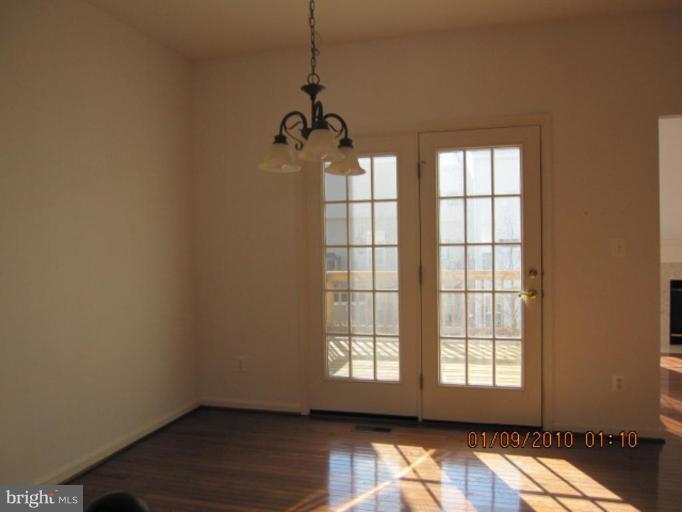 10168 Elgin Way Bristow, VA 20136 - Photo 4 of 6 a view of wooden floor and windows in a room