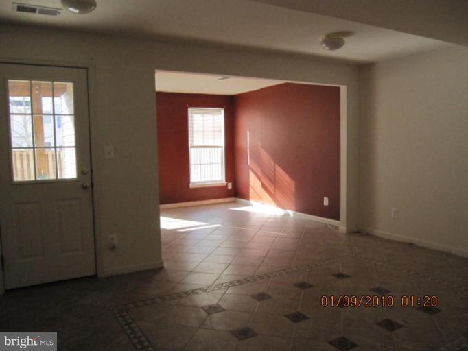 10168 Elgin Way Bristow, VA 20136 - Photo 6 of 6 an empty room with windows